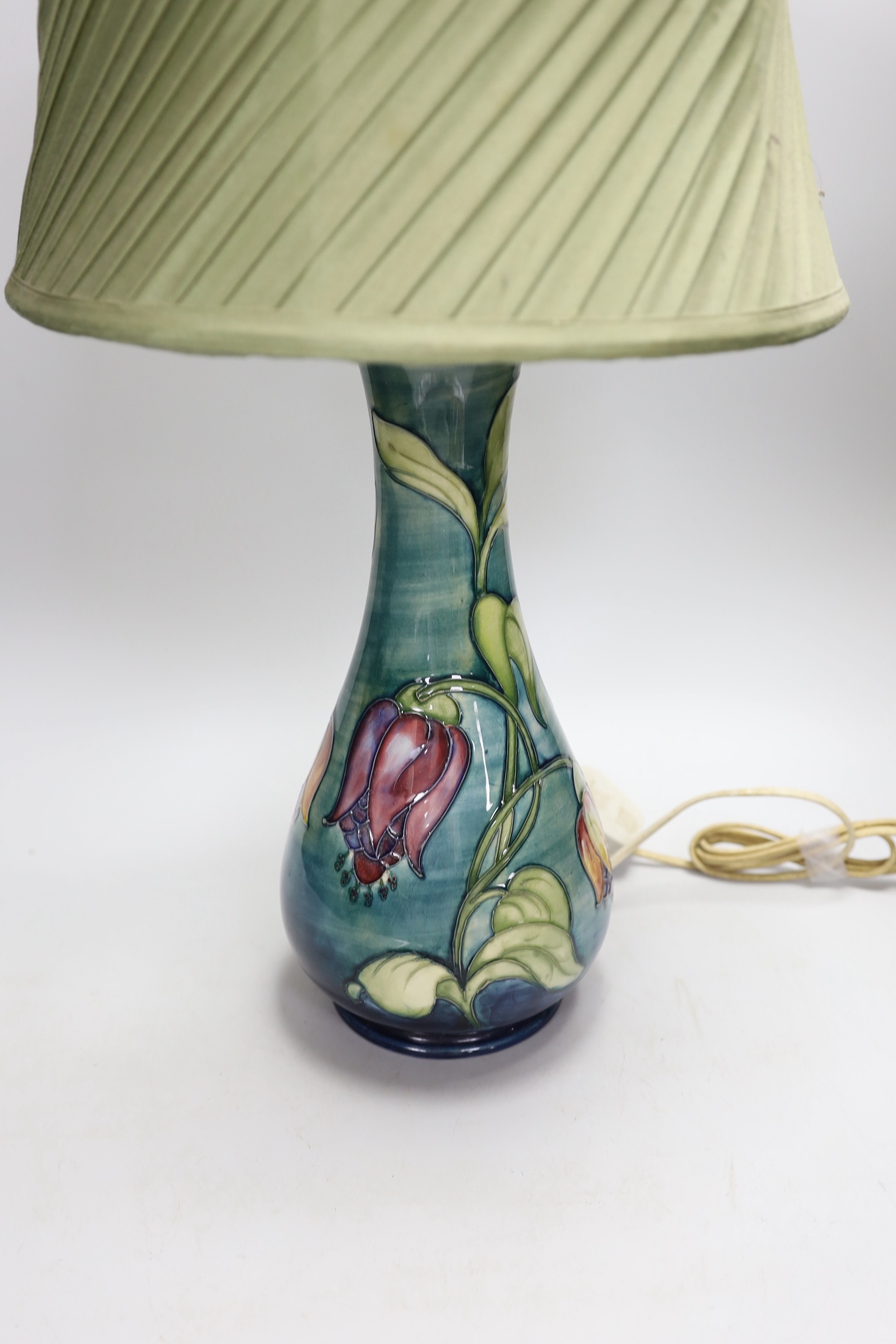 A 20th century Moorcroft lamp, stamped and with a Moorcroft label on the base, 35cms high (not including light fitting)